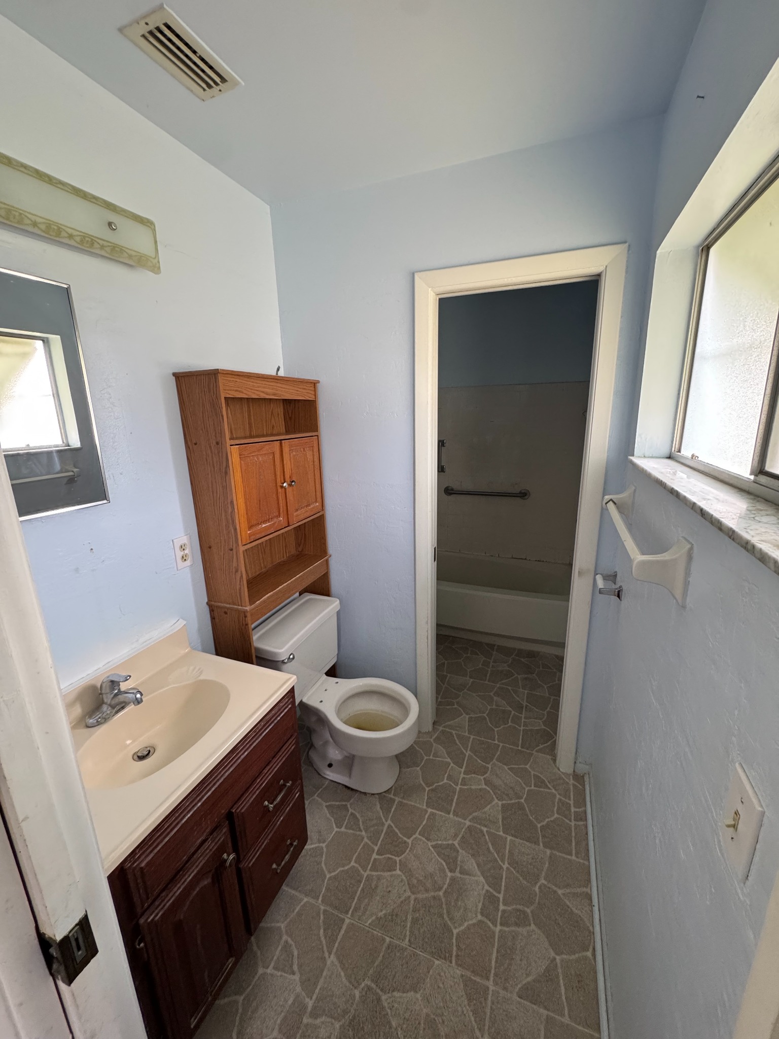 Bathroom with blue walls before renovation