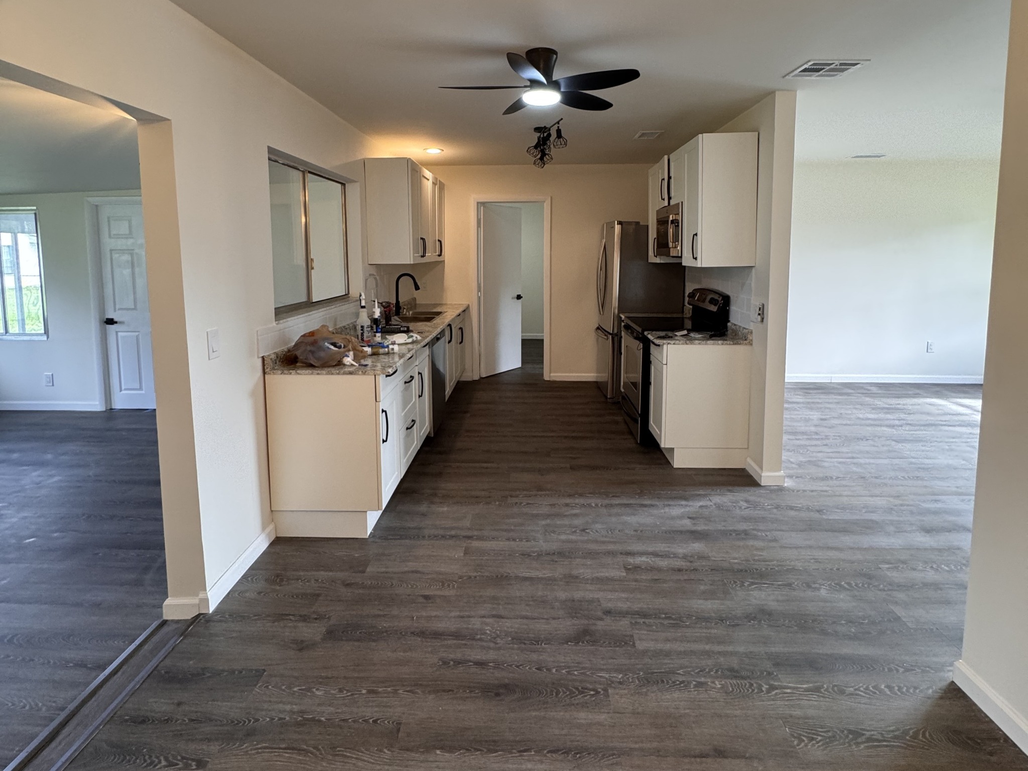 Renovated kitchen cabinetry, new flooring, and freshly painted walls and ceiling