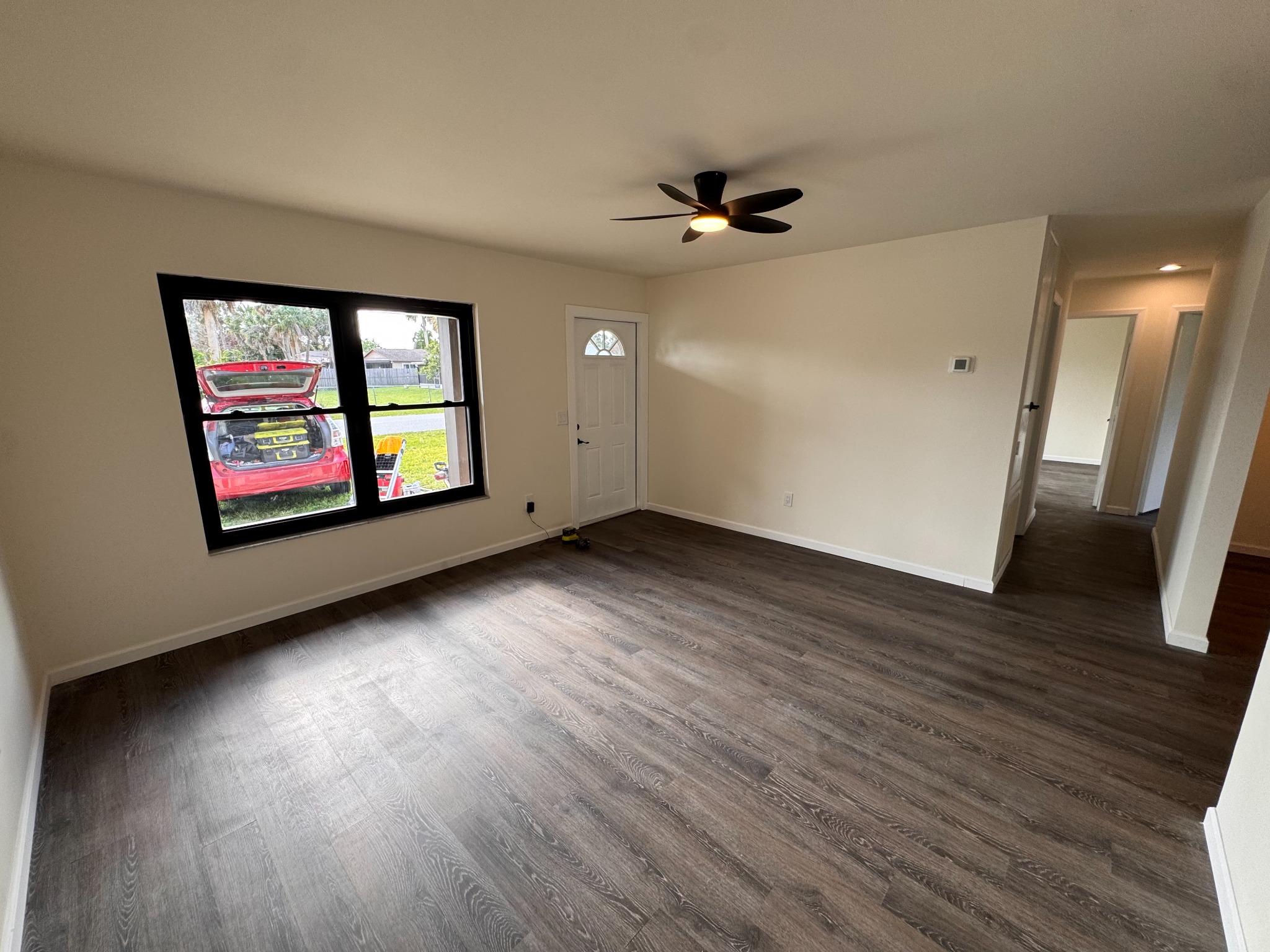 Living room with repaired and repainted walls and new flooring